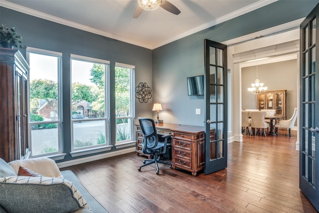 office space featuring dark wood-type flooring, ornamental molding, ceiling fan with notable chandelier, and french doors