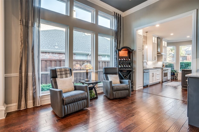 living area with dark hardwood / wood-style flooring and crown molding