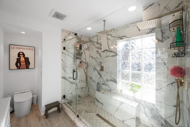 bathroom featuring toilet, hardwood / wood-style flooring, and walk in shower