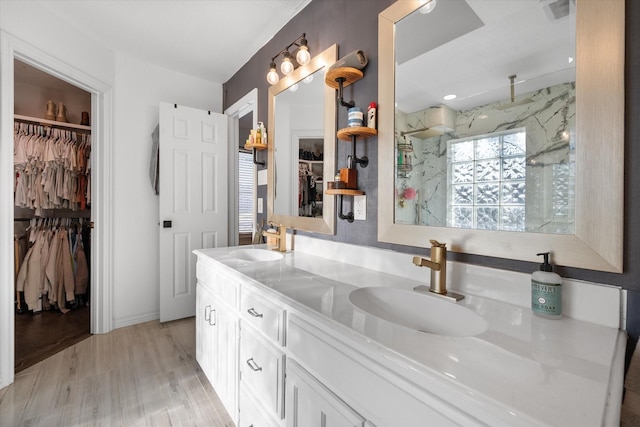 bathroom featuring vanity, a shower, and hardwood / wood-style floors