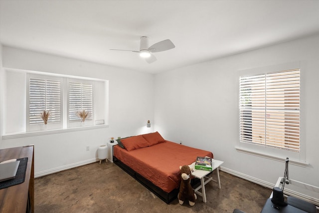 bedroom with ceiling fan and dark colored carpet