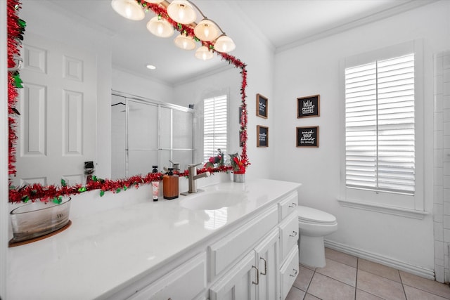 bathroom with toilet, vanity, tile patterned floors, crown molding, and a shower with door