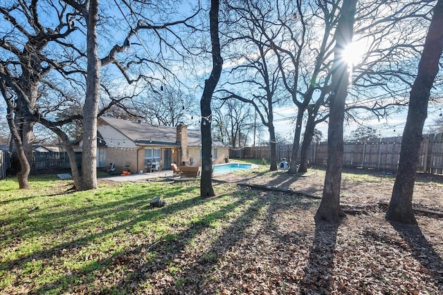 view of yard with a fenced in pool and a patio