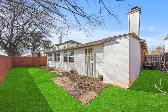 back of house with a lawn