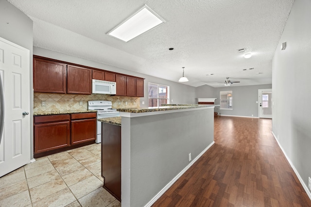 kitchen featuring ceiling fan, decorative backsplash, white appliances, hanging light fixtures, and stone countertops