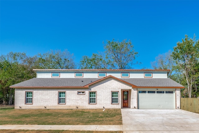 view of property with a front yard and a garage