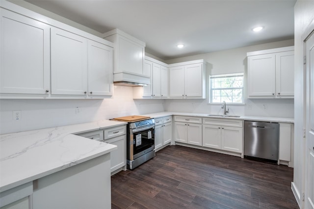 kitchen featuring sink, dark wood-type flooring, light stone countertops, stainless steel appliances, and white cabinets