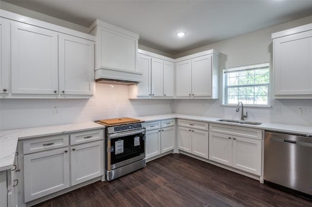 kitchen with stainless steel appliances, white cabinetry, and sink