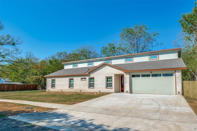 view of front property featuring a garage and a front yard