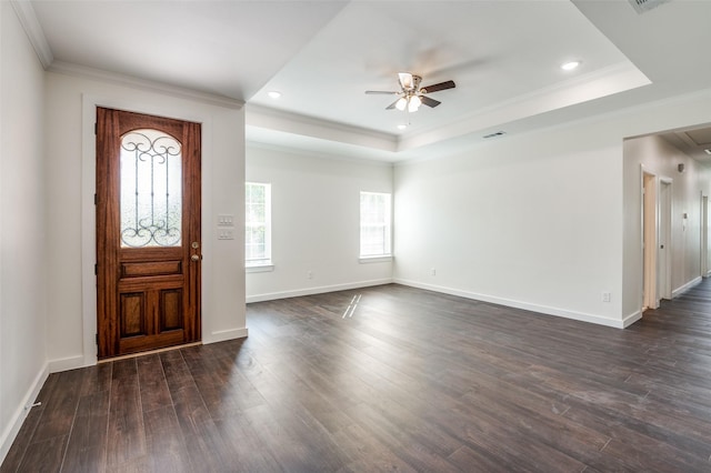 foyer entrance featuring dark hardwood / wood-style floors, ceiling fan, crown molding, and a raised ceiling