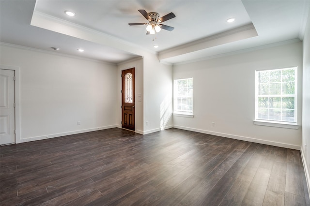 unfurnished living room with ceiling fan, dark hardwood / wood-style flooring, crown molding, and a raised ceiling