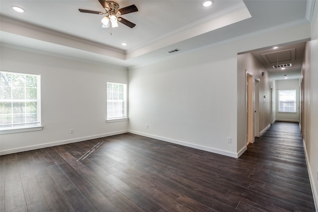 empty room featuring ceiling fan, dark hardwood / wood-style flooring, ornamental molding, and a raised ceiling