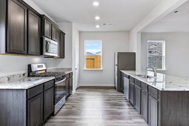 kitchen featuring dark wood-type flooring, dark brown cabinets, sink, and stainless steel appliances