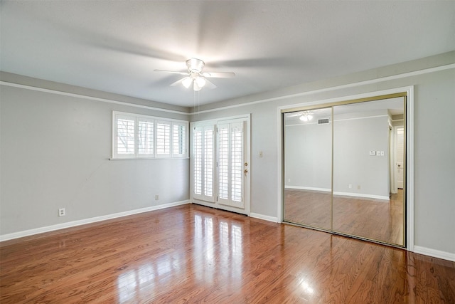 unfurnished bedroom featuring ceiling fan and hardwood / wood-style flooring