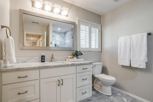 bathroom with toilet, vanity, and walk in shower