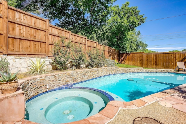 view of pool with an in ground hot tub