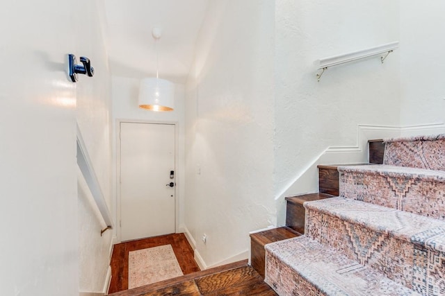 stairway featuring wood-type flooring