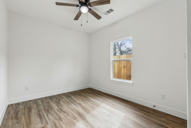 unfurnished room with ceiling fan and hardwood / wood-style flooring