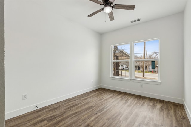 empty room with ceiling fan and hardwood / wood-style flooring