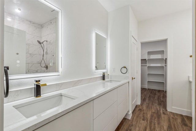 bathroom with a shower, hardwood / wood-style flooring, and vanity