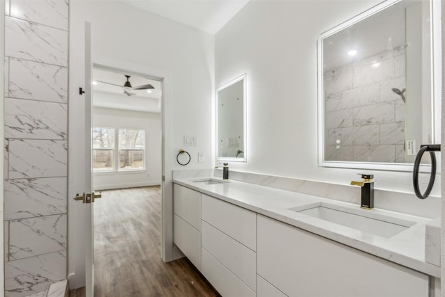 bathroom featuring ceiling fan, wood-type flooring, and vanity