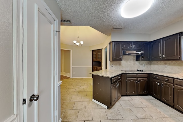 kitchen with tasteful backsplash, a chandelier, black electric cooktop, dark brown cabinetry, and pendant lighting