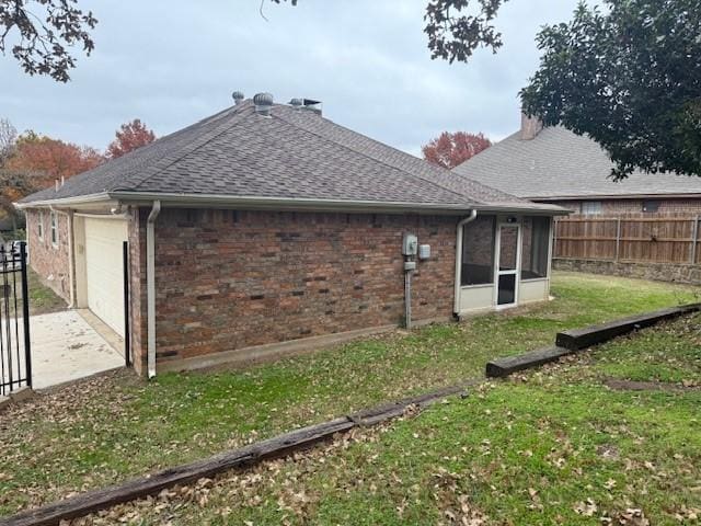 view of property exterior featuring a yard and a sunroom