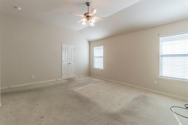 unfurnished room featuring lofted ceiling, light colored carpet, and ceiling fan