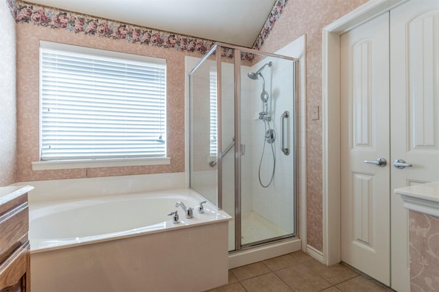 bathroom with tile patterned flooring, separate shower and tub, and vanity