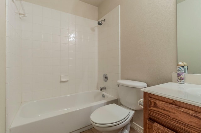 full bathroom with toilet, tiled shower / bath, and vanity