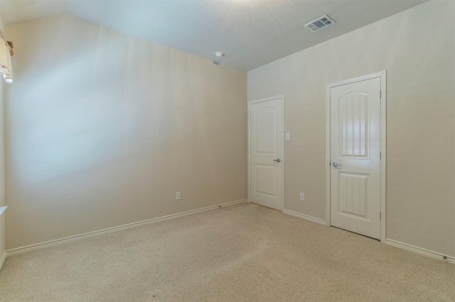 spare room featuring light colored carpet