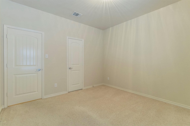 spare room with light colored carpet