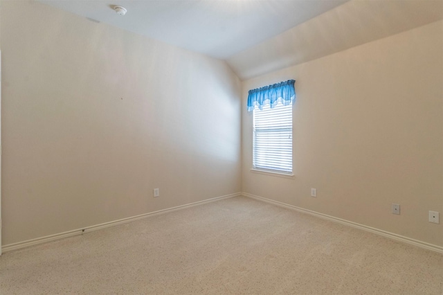 empty room with vaulted ceiling