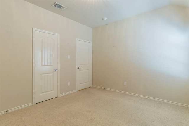 unfurnished room with light colored carpet