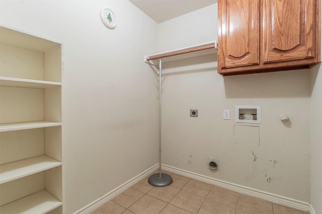 clothes washing area featuring cabinets, washer hookup, hookup for an electric dryer, light tile patterned floors, and gas dryer hookup