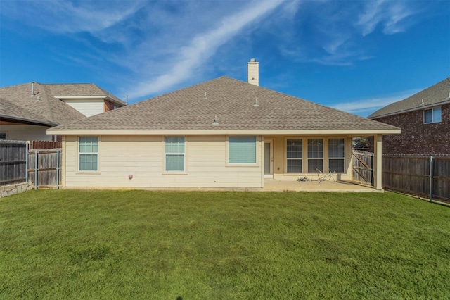 back of property with a yard and a patio