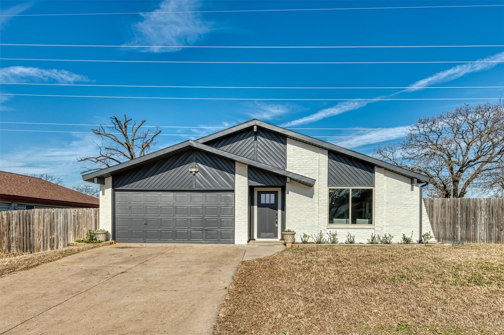 view of front facade with a garage and a front lawn