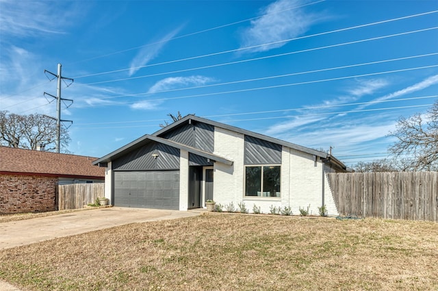 view of front of home with a garage and a front yard