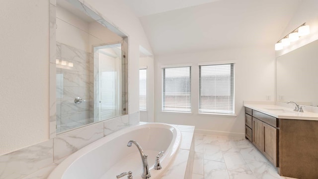 bathroom with vanity, walk in shower, a bath, and marble finish floor