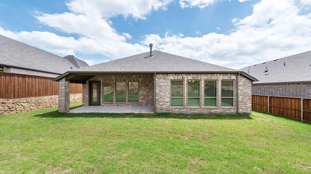 rear view of house with a fenced backyard, a lawn, a patio area, and brick siding