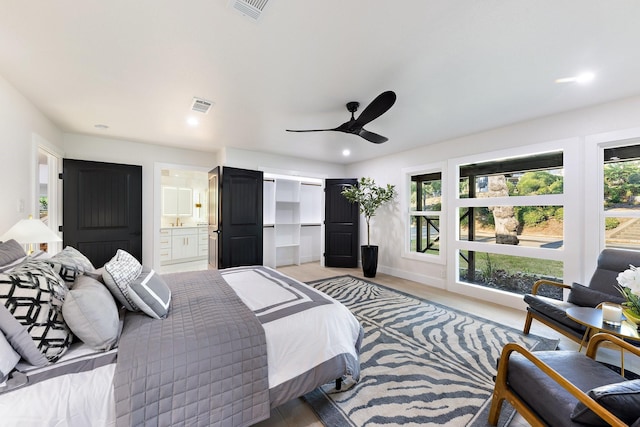 bedroom featuring ceiling fan, connected bathroom, and multiple windows