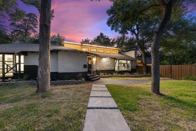 view of front of home featuring a lawn