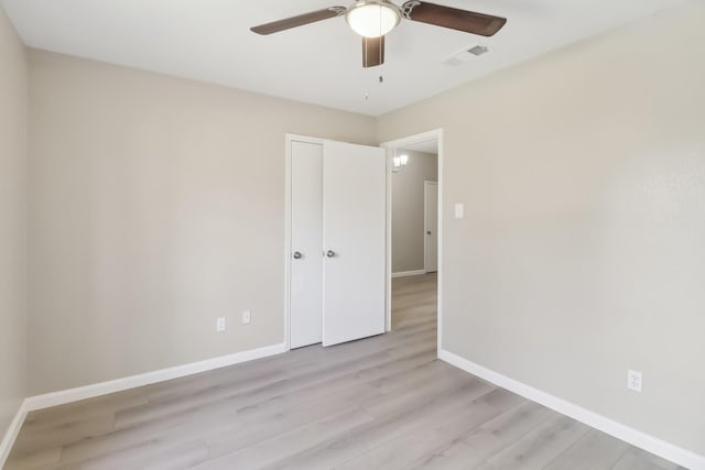 empty room featuring ceiling fan and light hardwood / wood-style flooring