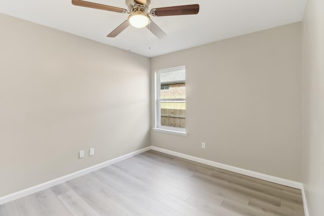 empty room with ceiling fan and light hardwood / wood-style flooring