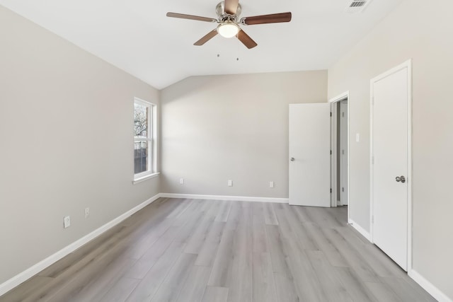 empty room featuring ceiling fan, light hardwood / wood-style flooring, and lofted ceiling