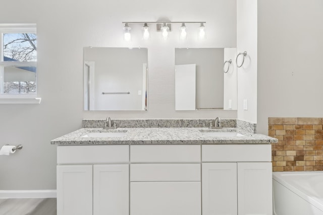 bathroom featuring a tub to relax in and vanity