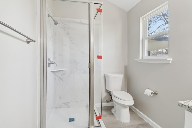 bathroom with toilet and a shower with shower door