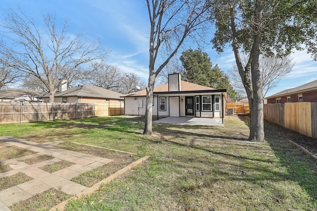 rear view of property featuring a yard and a patio