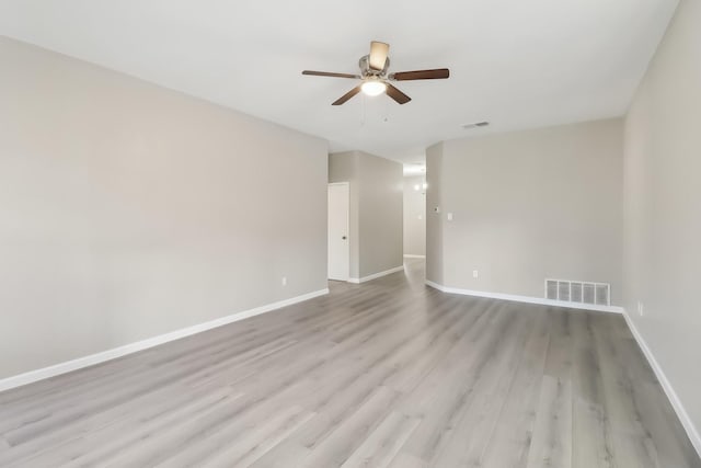 empty room with ceiling fan and light hardwood / wood-style floors