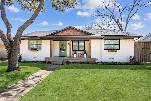 view of front facade featuring a porch, crawl space, brick siding, and a front lawn